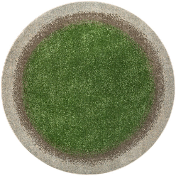 A round green and brown area rug with grass on it.