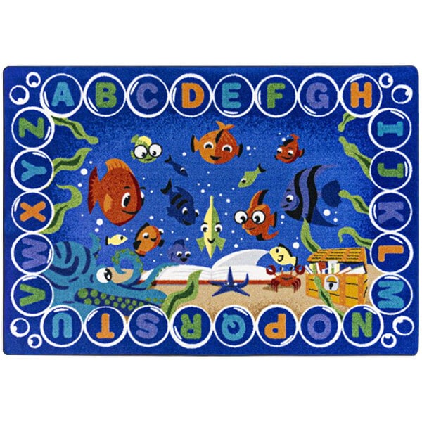 A white rectangular area rug with a blue border, blue letters, and underwater scenes including fish.