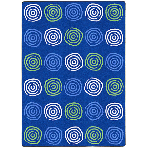 A seaglass blue rectangular area rug with white circles and green and blue swirls.