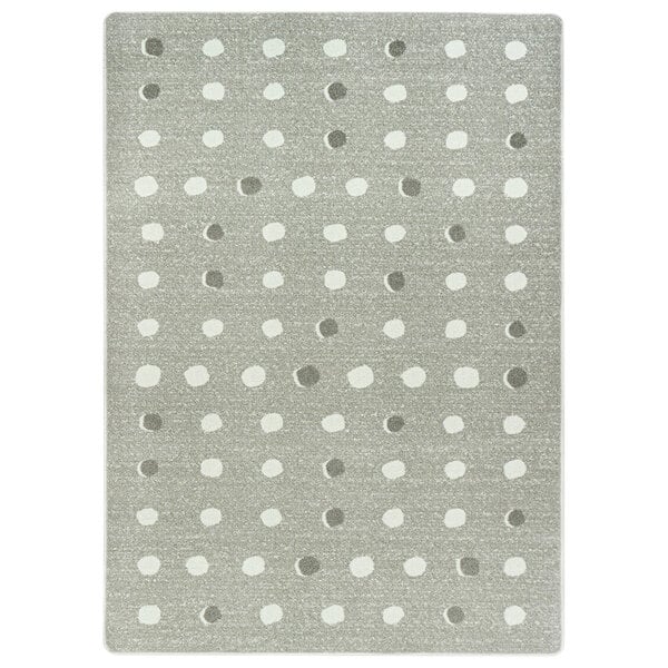 A linen area rug with grey and white dots.