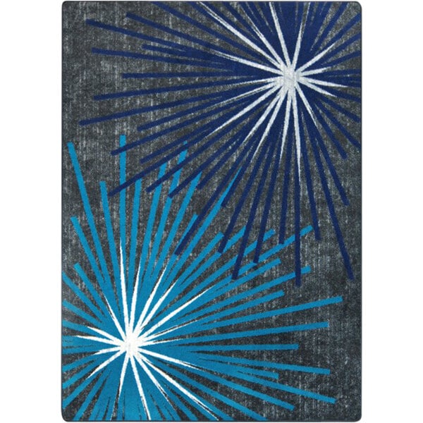 A Joy Carpets rectangular area rug with a blue and white sunburst design.