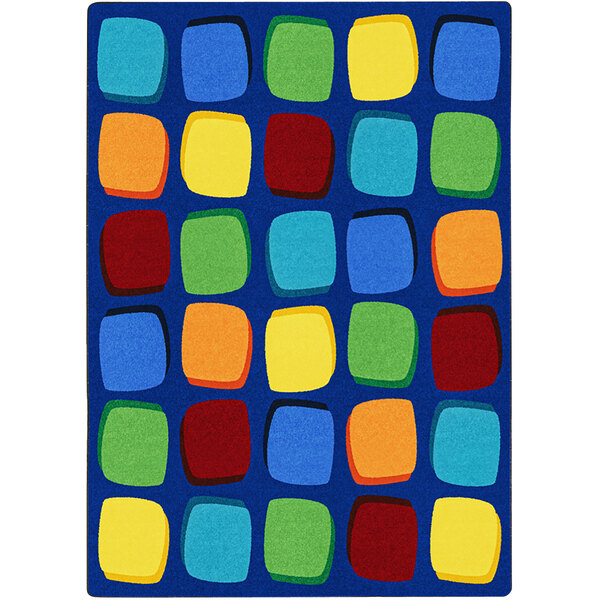 A blue rectangular area rug with multicolored squares in a yellow and blue square pattern.