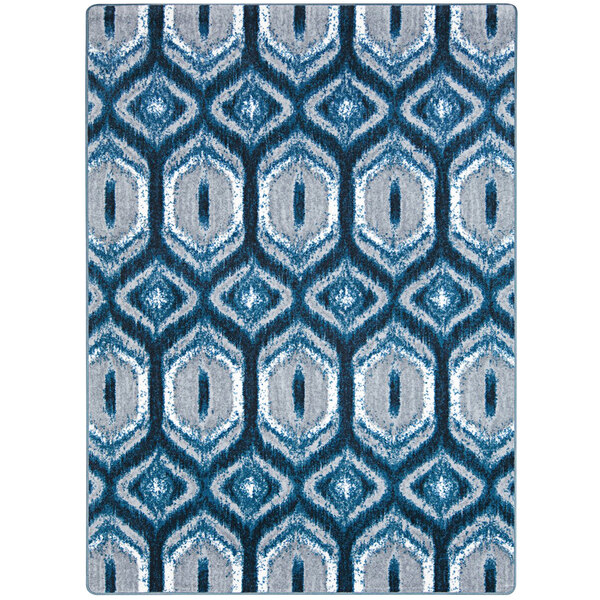 A blue and white Joy Carpets area rug with geometric patterns.