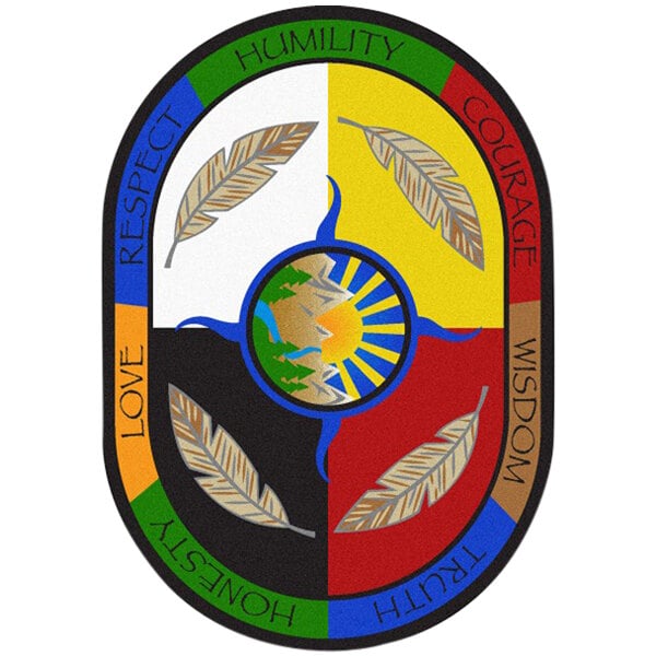 A colorful oval area rug with a colorful patch featuring a mountain, sun, and feathers.