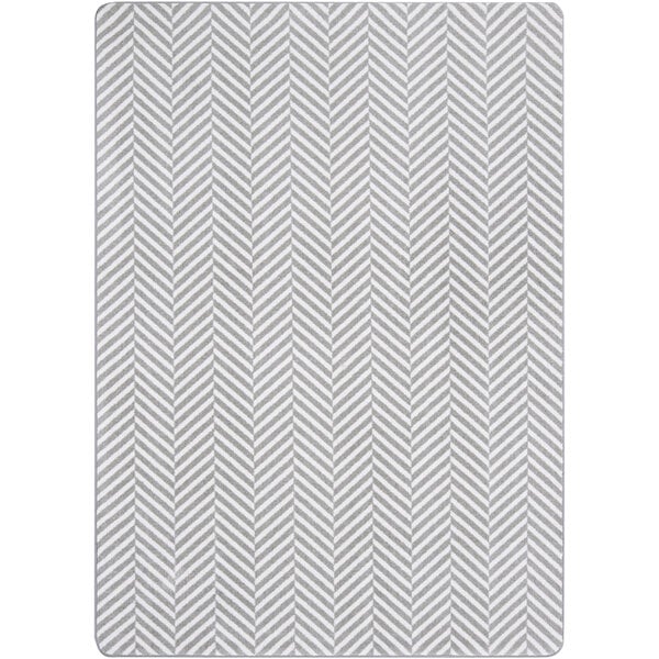 A Joy Carpets Morning Fog area rug with a grey and white chevron pattern and white border.