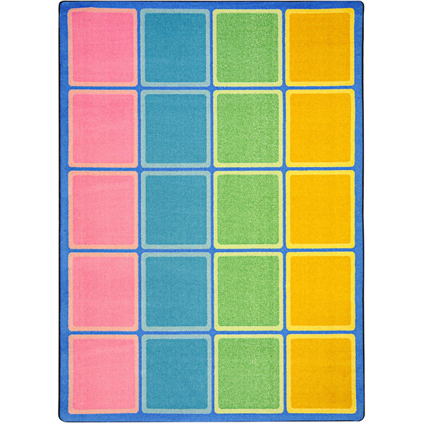 A pastel area rug with colorful squares and a blue border.