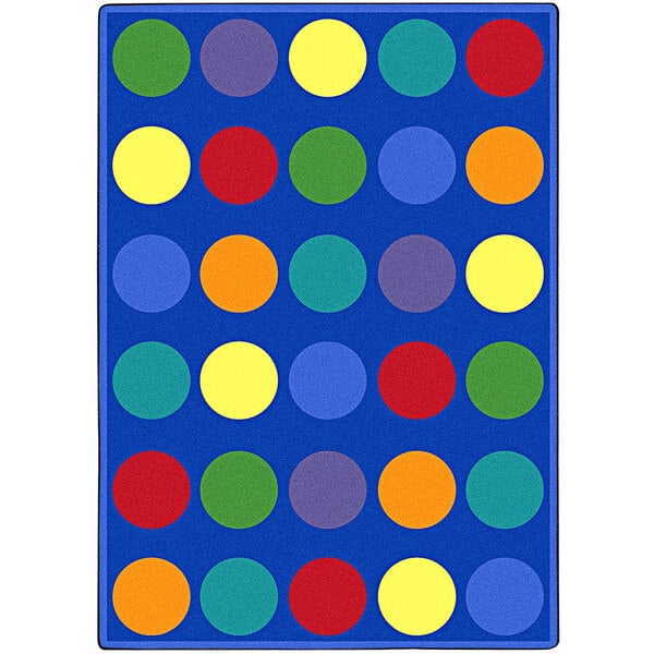 A blue rectangle rug with multicolored circles on it.