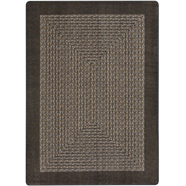A close up of a brown Joy Carpets rectangular area rug with a geometric design.