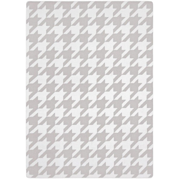 A white and grey houndstooth rug with a checkered pattern.