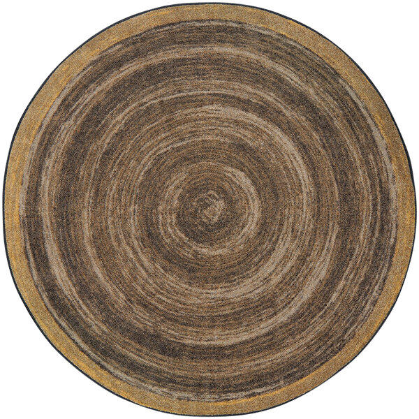 A Joy Carpets walnut round area rug with a circular pattern in brown and black.