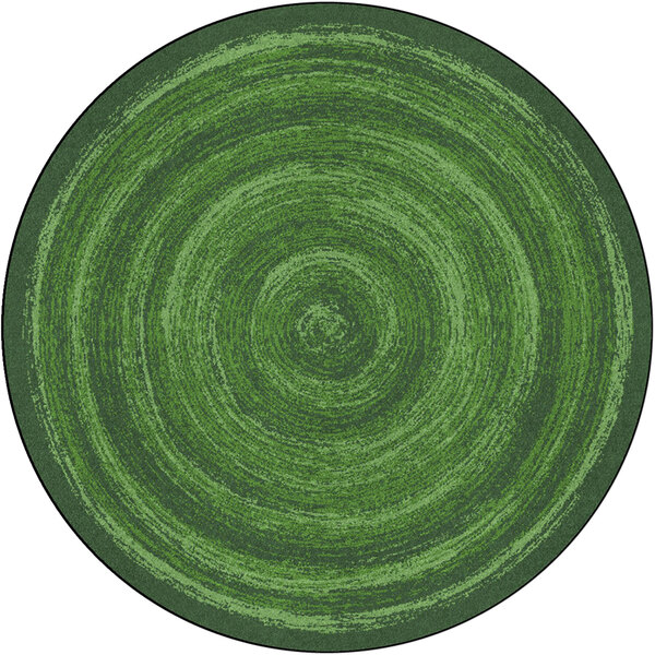 A green circular rug with a circular pattern and black border.