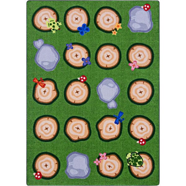 A Joy Carpets rectangular area rug with a pattern of trees and flowers in a circle.