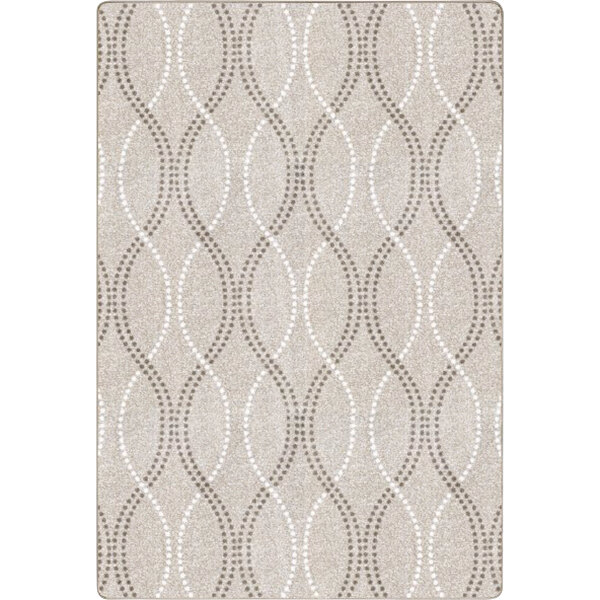A beige Joy Carpets area rug with a pattern of circles.