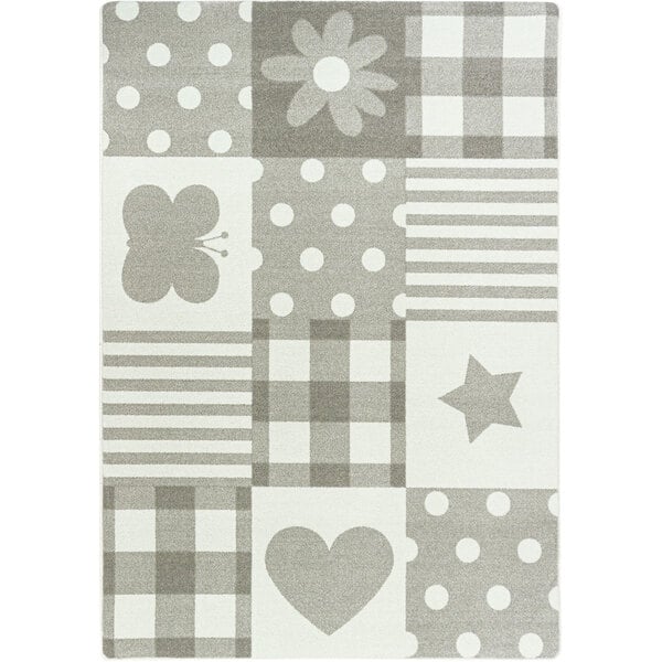 A Joy Carpets area rug with a grey and white patchwork design including a butterfly, star, and flower.