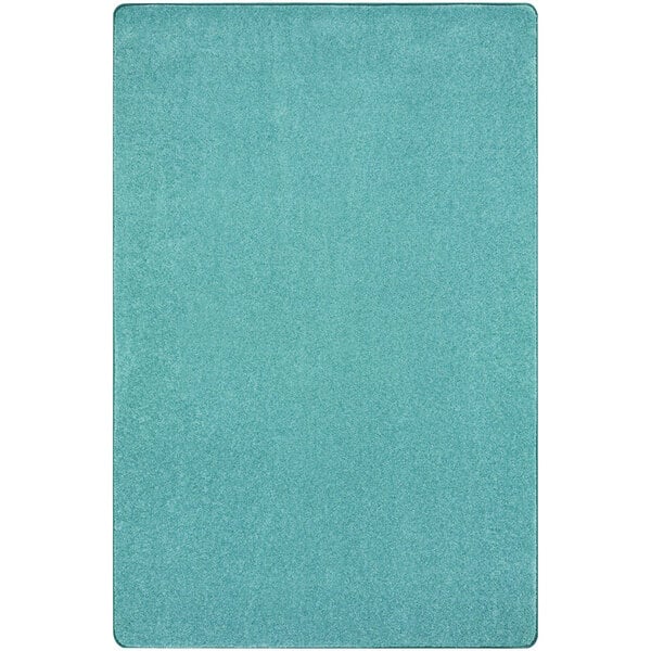 A seafoam rug with a blue and white square pattern.