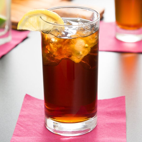 A Libbey highball glass of iced tea with a lemon wedge.