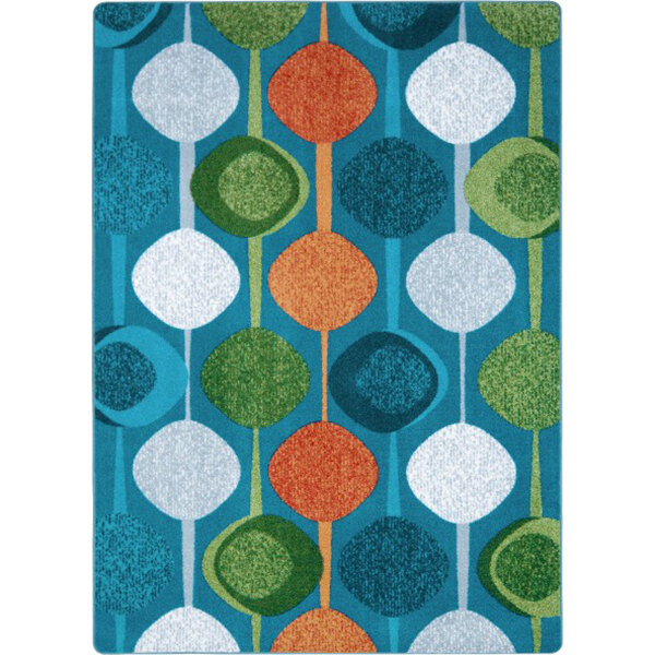 A close-up of a Joy Carpets citrus rectangular area rug with colorful circles and dots.