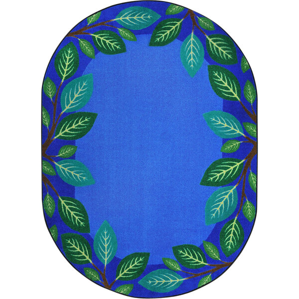 A blue oval rug with green leaves on it.