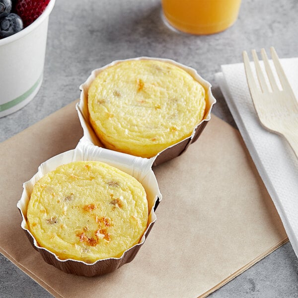 Artisan Kitchens Sausage and Three Cheese Egg Bites in a paper cup.