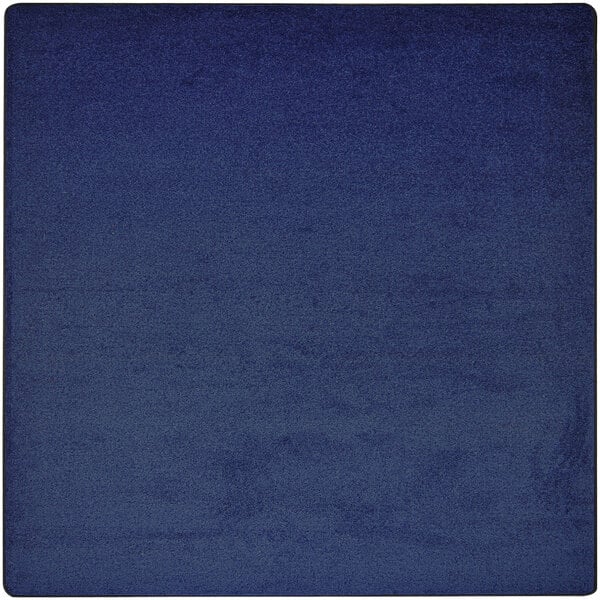 A dark blue square Joy Carpets Kid Essentials area rug with a lighter blue square in the center.