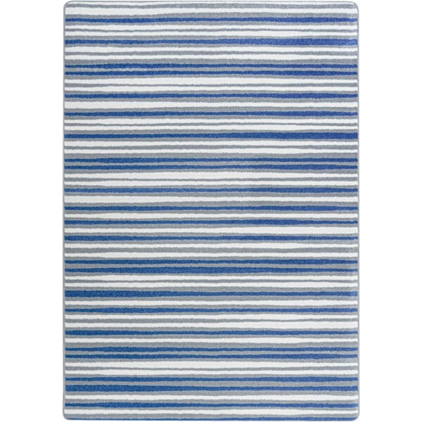 A close up of a Joy Carpets Claremont Kids Between the Lines blue and white striped area rug.