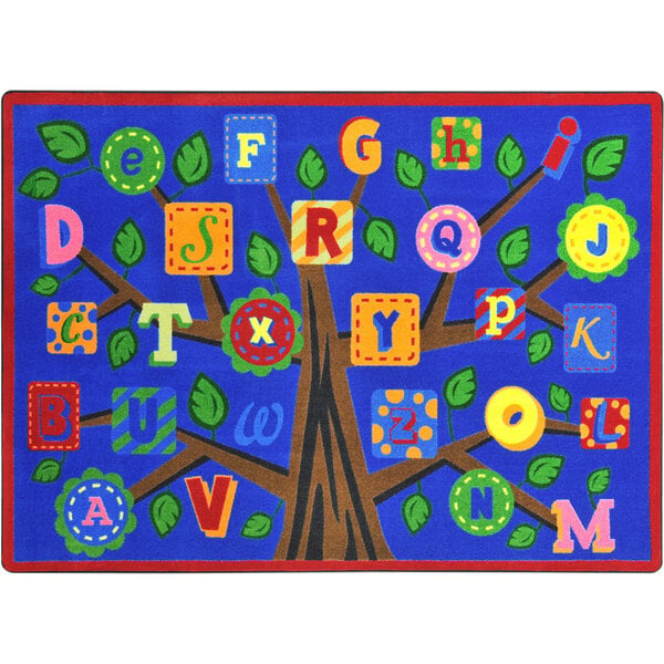 A white rectangular area rug with a colorful tree and alphabet letters on it.