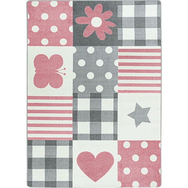 A pink and grey rectangular area rug with different patterns including hearts and flowers.