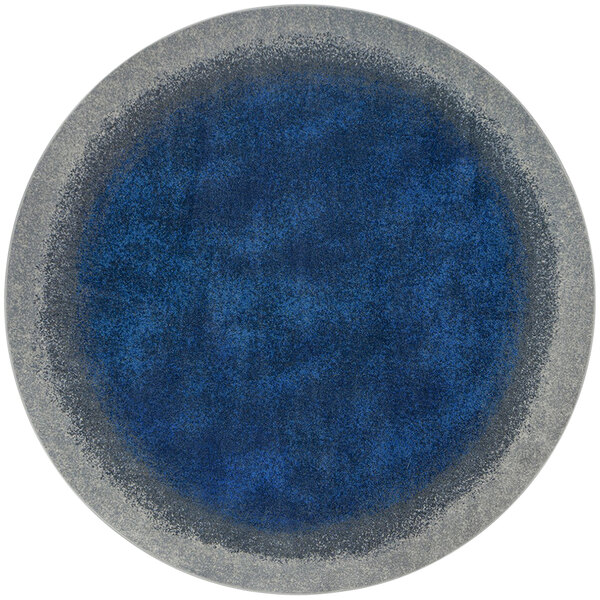 A round white rug with a blue and grey circle design.