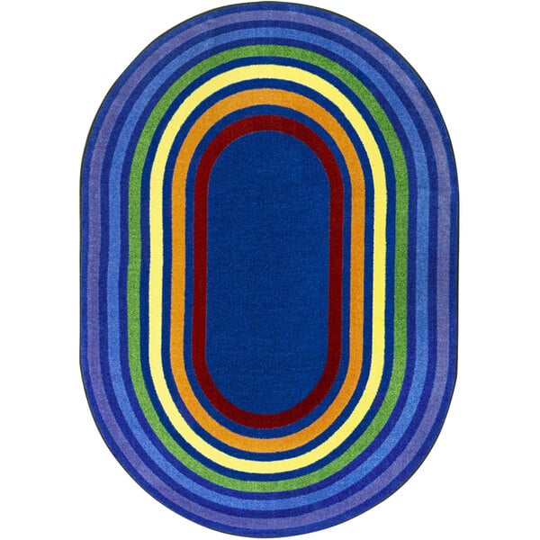 A multicolored oval rug with a rainbow stripe.