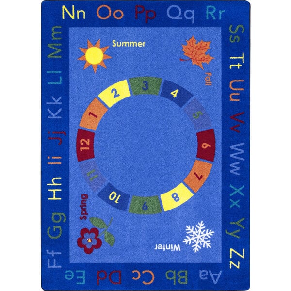 A multi-colored rectangle area rug with a blue border and a white background with colorful circles, numbers, and letters.