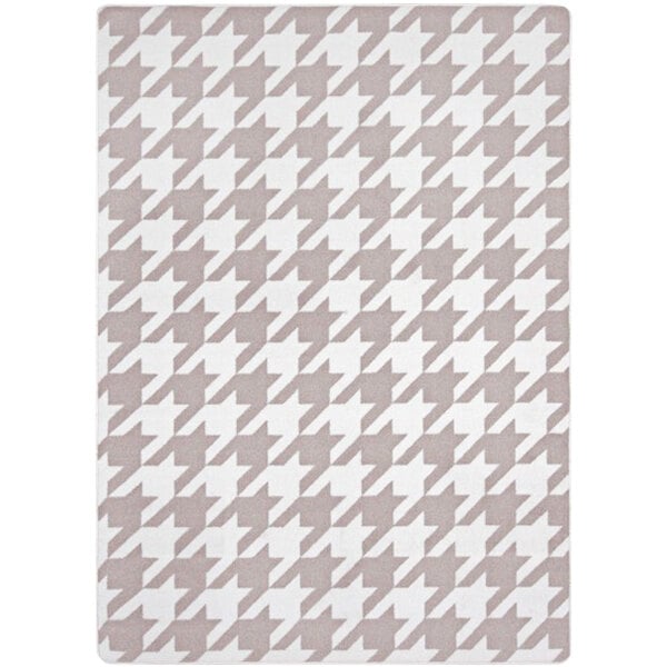 A taupe rectangular area rug with a houndstooth pattern in white.