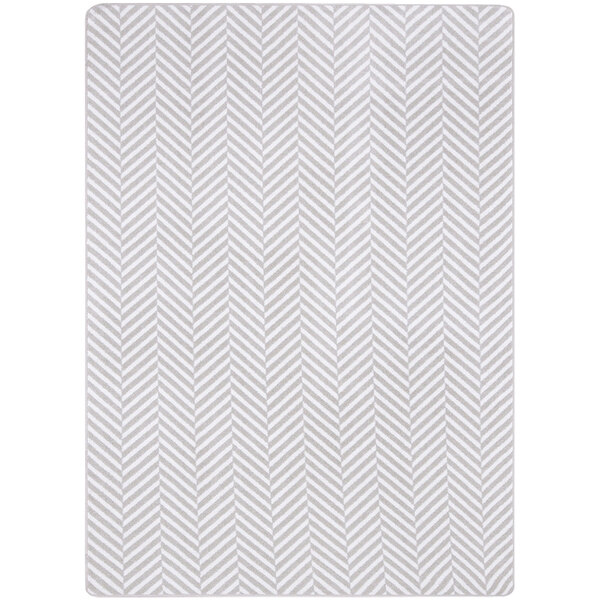 A white rectangular area rug with a grey chevron pattern.