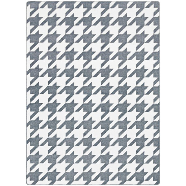 A close-up of a grey and white houndstooth Joy Carpets area rug.