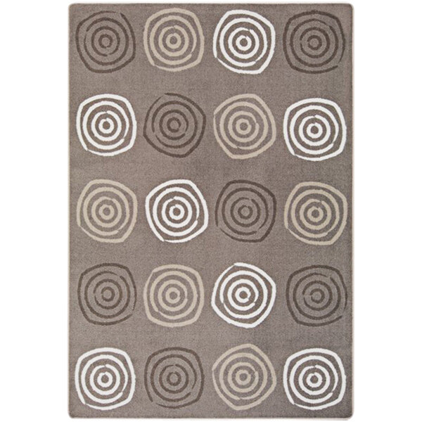 A Joy Carpets rectangular area rug with brown circles and swirls on it.