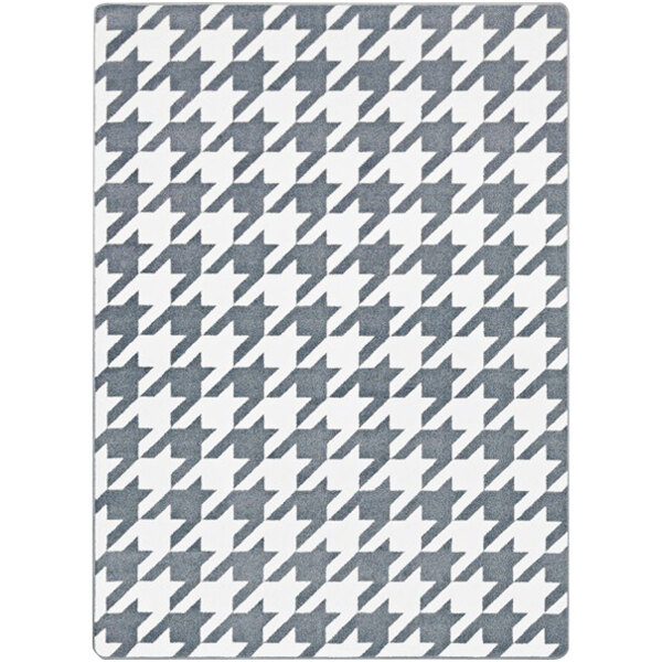 A close-up of a grey and white houndstooth patterned Joy Carpets rectangular area rug.