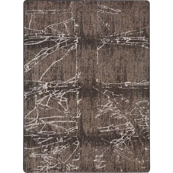 A close-up of a Joy Carpets Fractured Umber area rug with abstract designs in brown and white.