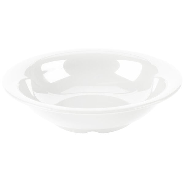 A white bowl with a narrow rim on a white surface.