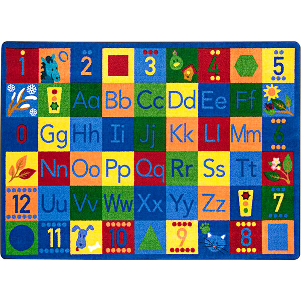 A white rectangular area rug with colorful letters and numbers on it.