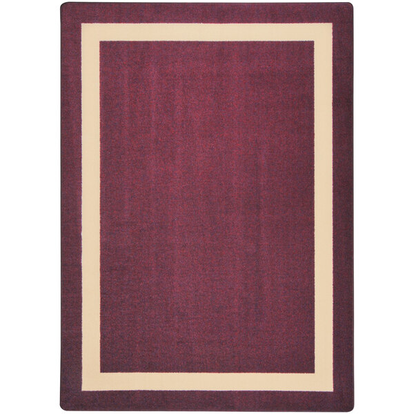 A close-up of a burgundy area rug with a beige border.