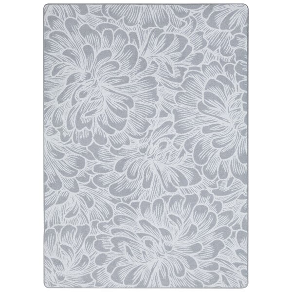 A white and gray rectangular area rug with white flowers on it.