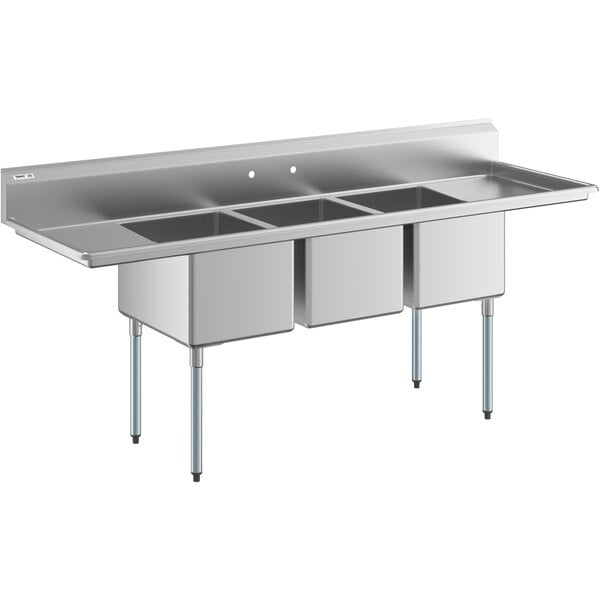 A Regency stainless steel three compartment sink with two drainboards.