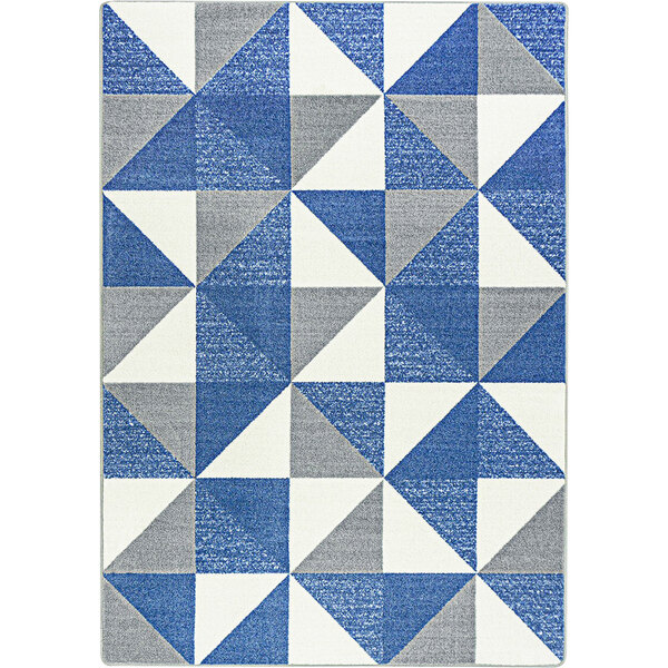 A blue, white, and grey Joy Carpets area rug with a triangle pattern.