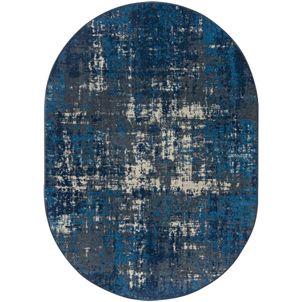 A close-up of a blue and white Joy Carpets Kid Essentials Terra Mae Marine oval area rug with a distressed look.