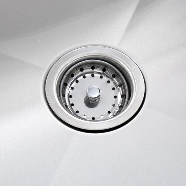 A close-up of the drain on a Regency stainless steel sink.