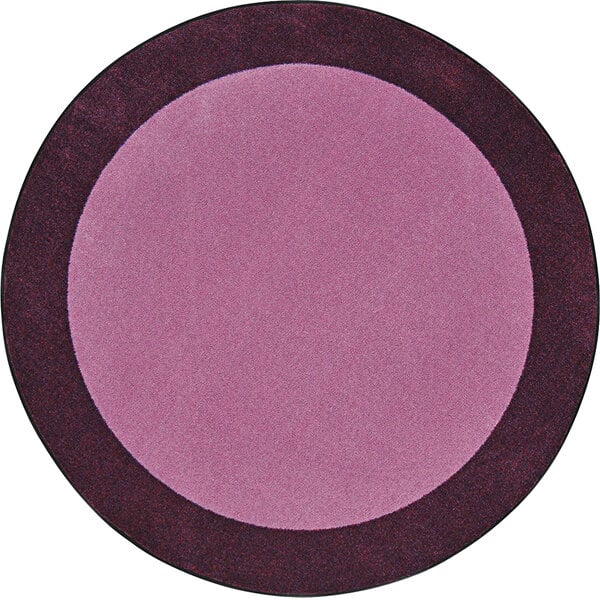 A purple circle rug with a black border and brown and purple designs.