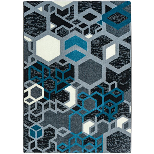 A Joy Carpets Kid Essentials area rug with a blue, black, and grey hexagon pattern.
