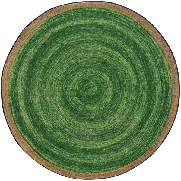 A white circular area rug with a green circular pattern.