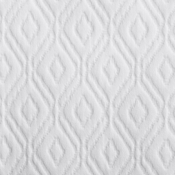 A close-up of a white textured fabric with a pattern.
