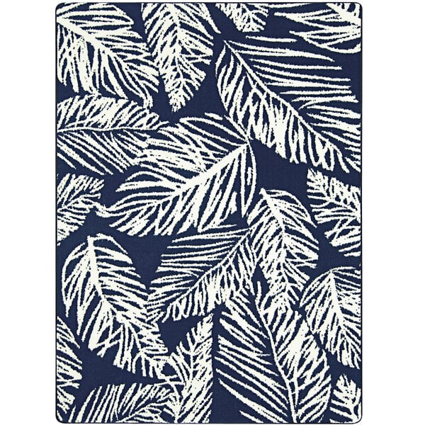A close-up of a blue and white Joy Carpets area rug with white leaves on it.