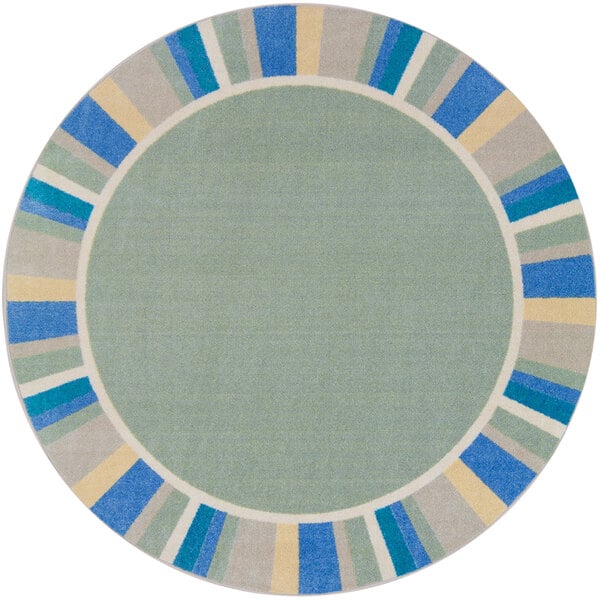 A round sage rug with a blue and yellow border.